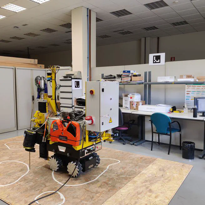 Mobile robot localization in industrial environments using a ring of cameras and ArUco markers